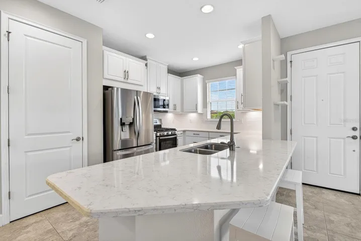 Large kitchen with quartz countertops