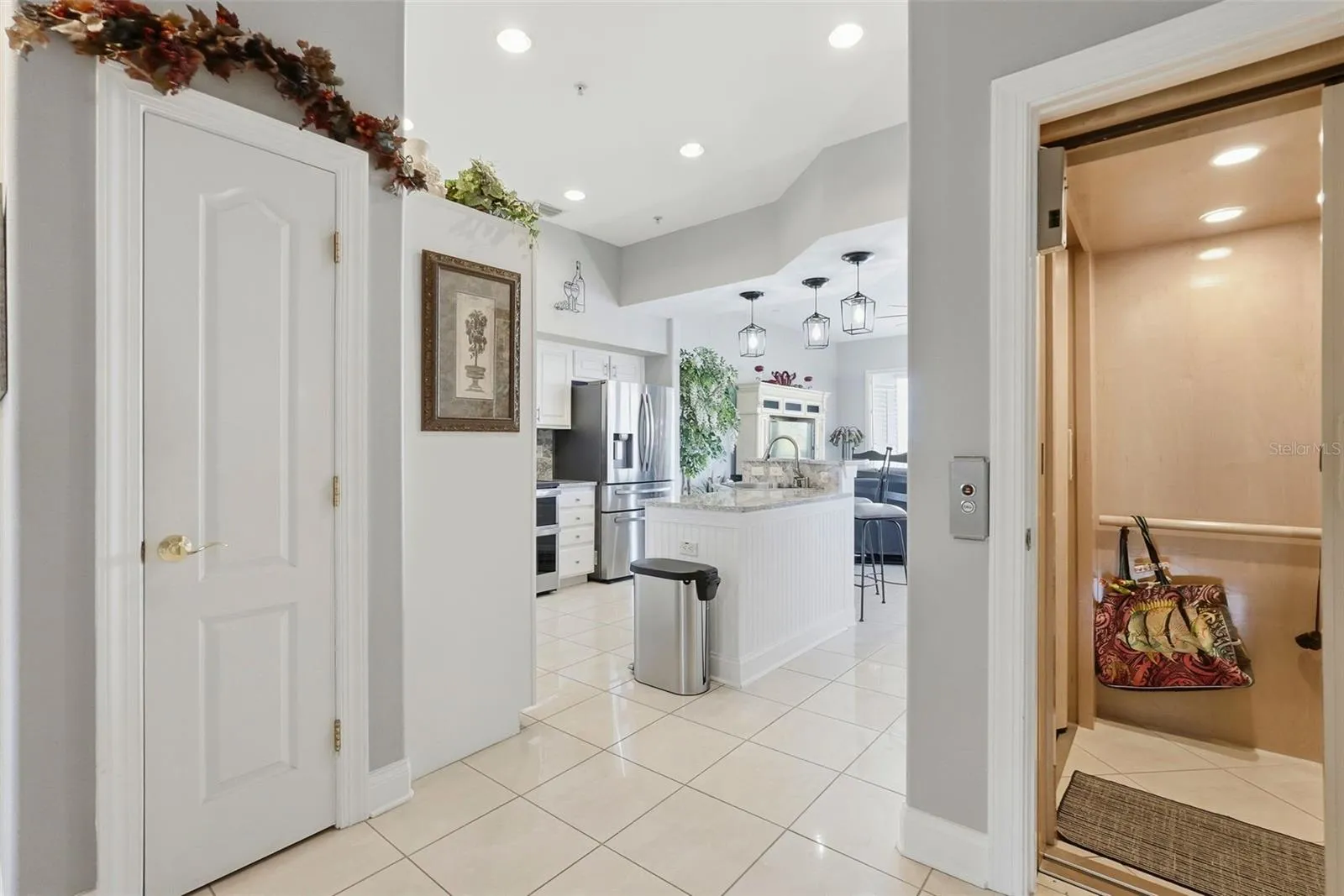 2nd level features high ceilings, a kitchen with an oversized quartz island opening into spacious waterfront living area with balcony and wide water views!