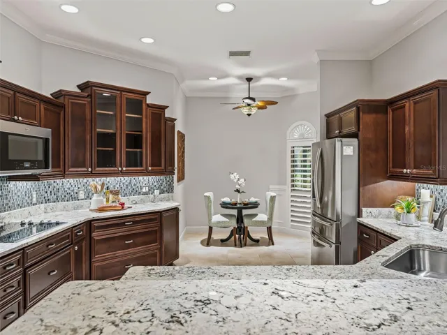 Granite counters, beautiful cabinetry, eating area in kitchen