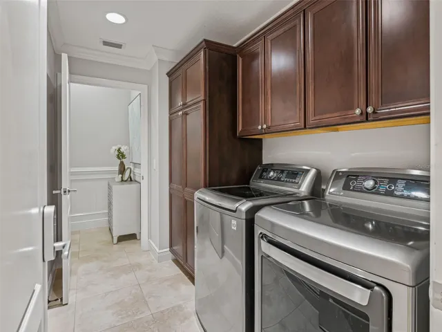 Inside laundry with additiional cabinets and storage