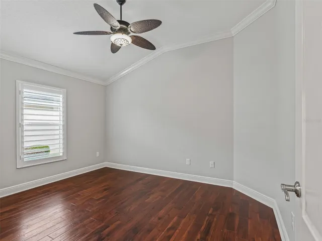 2nd bedroonm with closet, crown moulding, hand scraped wood floors and celing fan