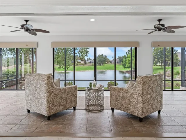 Florida room with electronic shades, windows are mirrored on the outside, stone tile floor, and AMAZING VIEW AND PRIVACY