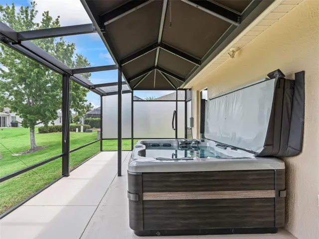 Exterior lanai with hot tub, privacy screen, canvas top, brand new Bullfrog hot tub
