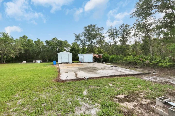 30ft by 40ft concrete pad 10in thick with power plus shed with tie-downs and container