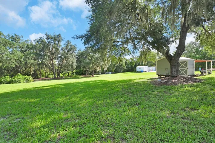 shed in back with carport