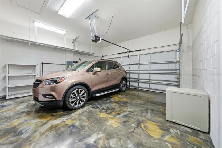 2 car garage with epoxy flooring and plenty of storage