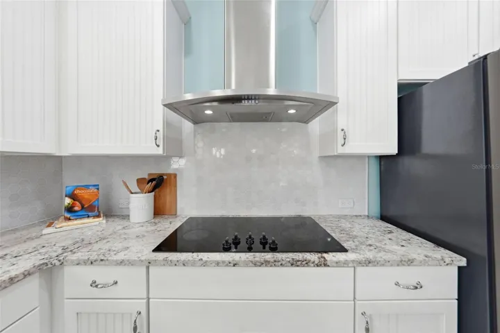 Glass cooktop with stainless steel hood