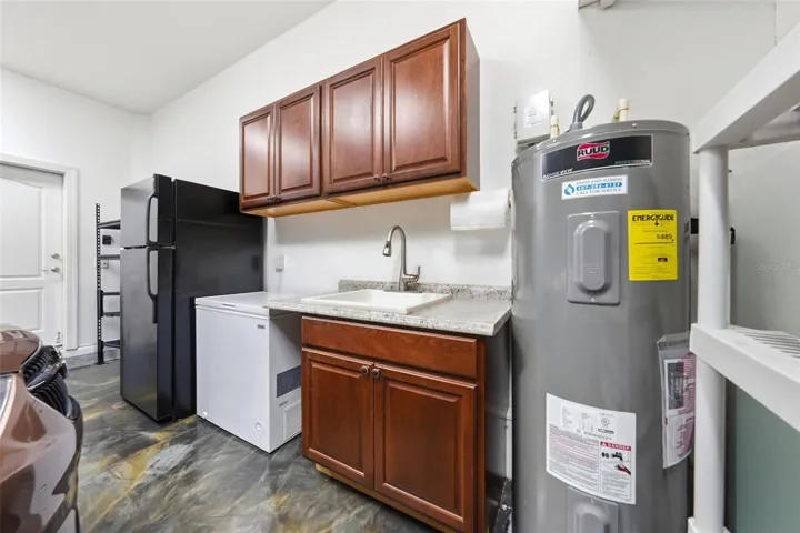 Additional cabinets for storage and utility sink in garage.
