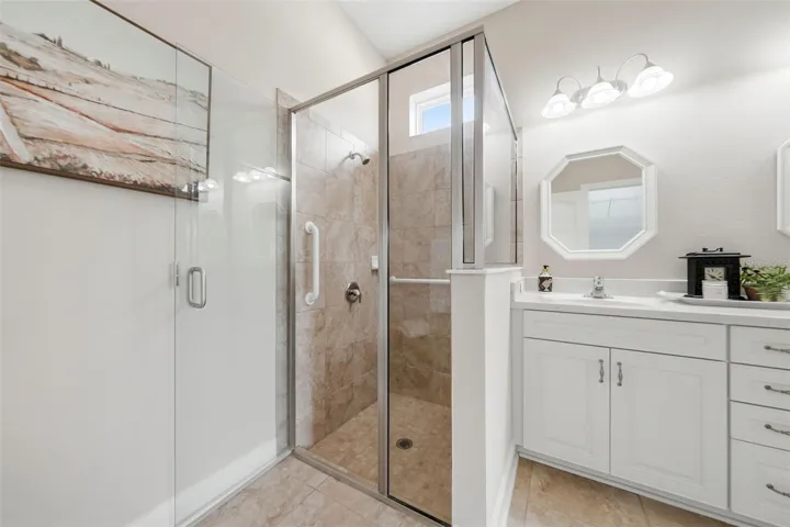 Tiled walk-in shower in Primary bathroom