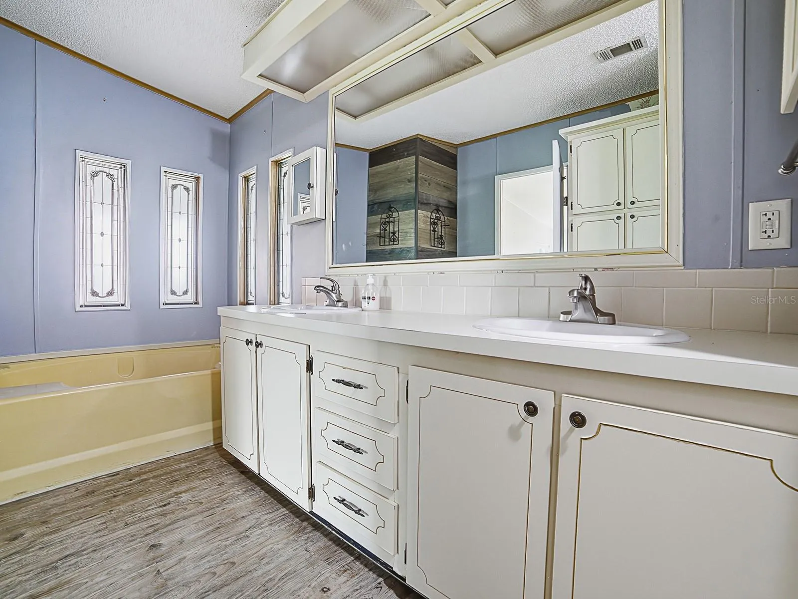 Owners private bathroom with double sinks and soaking tub