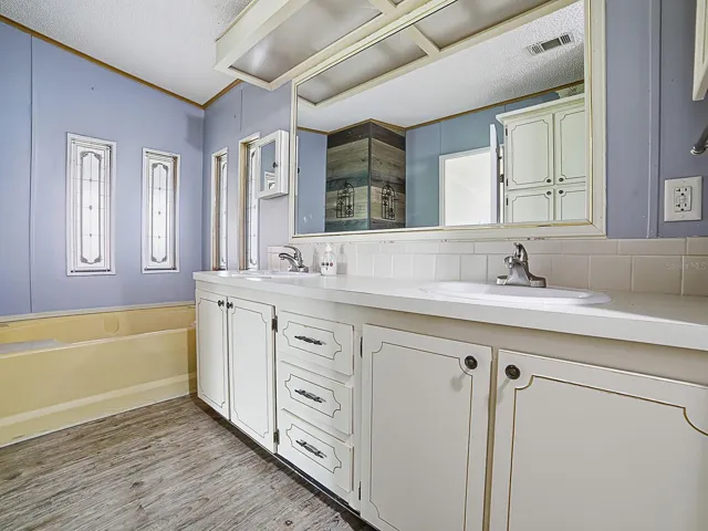 Owners private bathroom with double sinks and soaking tub