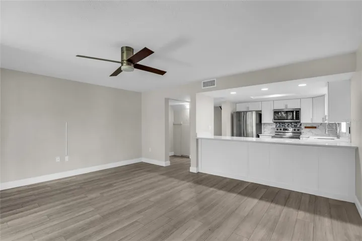 Living room includes a cozy dining area and opens to a covered patio and spacious yard that’s fully fenced in