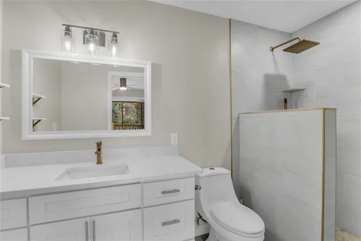 Primary ensuite bath features a tile walk-in shower, quartz vanity and modern finishes