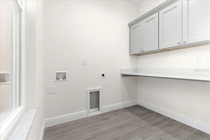 laundry room with granite countertop folding bar