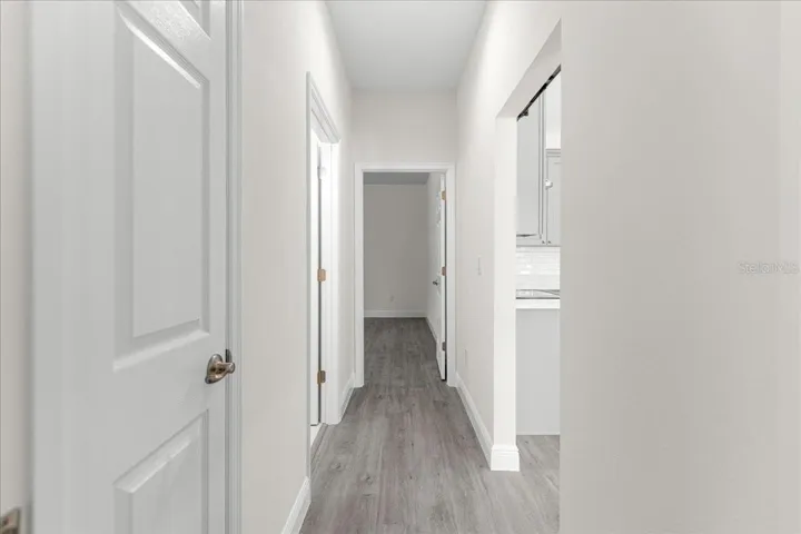 hallway for bedroom 2-3 with linen closet, full bathroom, Barn door offers privacy