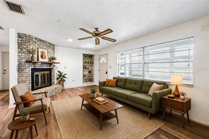 Living area features a cozy fireplace and built-in shelving. Virtually Staged.