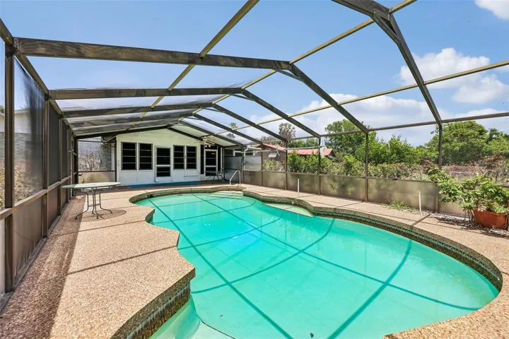 The huge enclosed lanai/Florida room opens to your private screened pool.