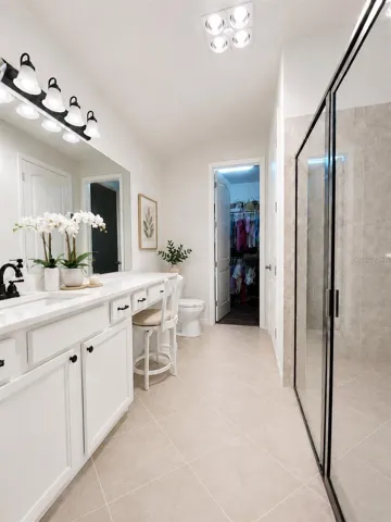 Luxurious Primary Bathroom with Expansive Walk-In Closet and Walk-In Shower