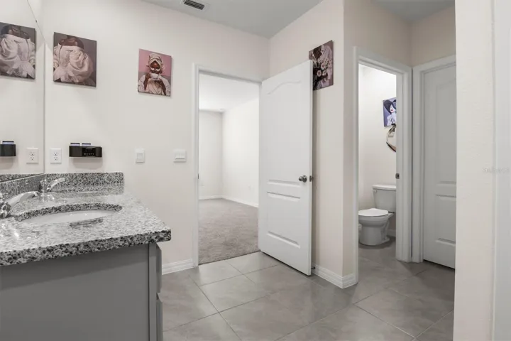 Primary bathroom with view to the bedroom