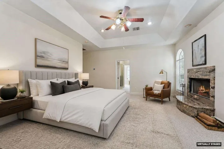 *Virtually Staged* Primary suite with a wood burning fireplace, en-suite bath & private balcony