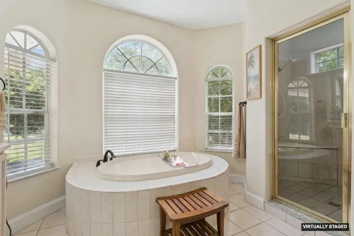 *Virtually Staged* en-suite bath with a large shower with steam feature