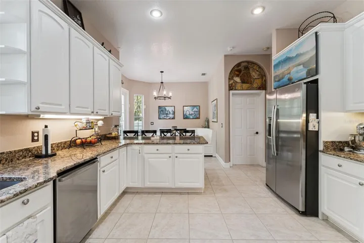 Beautiful kitchen with under cabinet lighting, a breakfast bar and breakfast nook