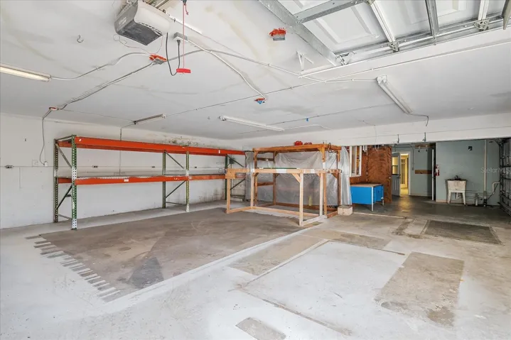 Storage/workspace accessible from two overhead doors or lower unit entry