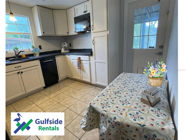 Adorable kitchen leads out to the rear screen porch!