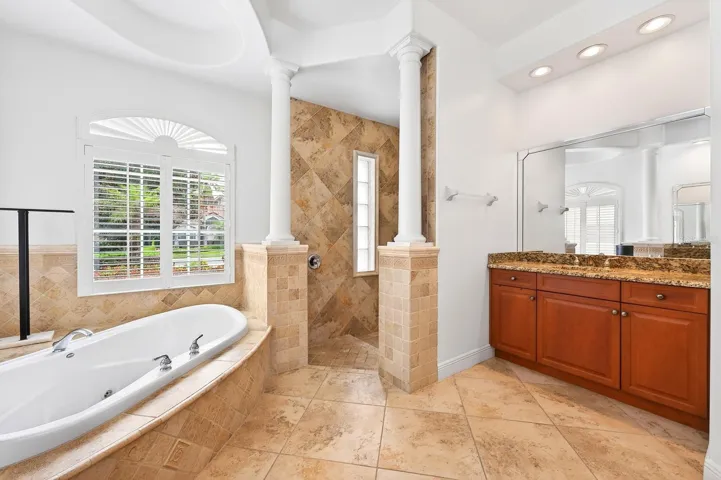 The Primary En suite features a tray ceiling, dual vanities, a jetted garden tub, walk-in shower, and private water closet.