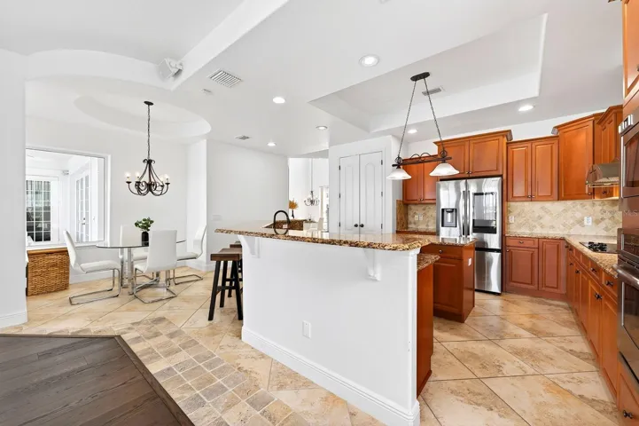 A SUNLIT BREAKFAST NOOK offers peaceful views of the pool and patio area.