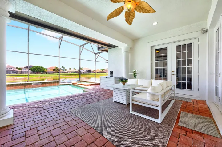 Experience ultimate relaxation in your backyard sanctuary, complete with a SCREENED-IN HEATED POOL, soothing spa, and a NEW POOL HEATER (2023), all while taking in SCENIC VIEWS of the Providence Golf Club's picturesque water feature.
