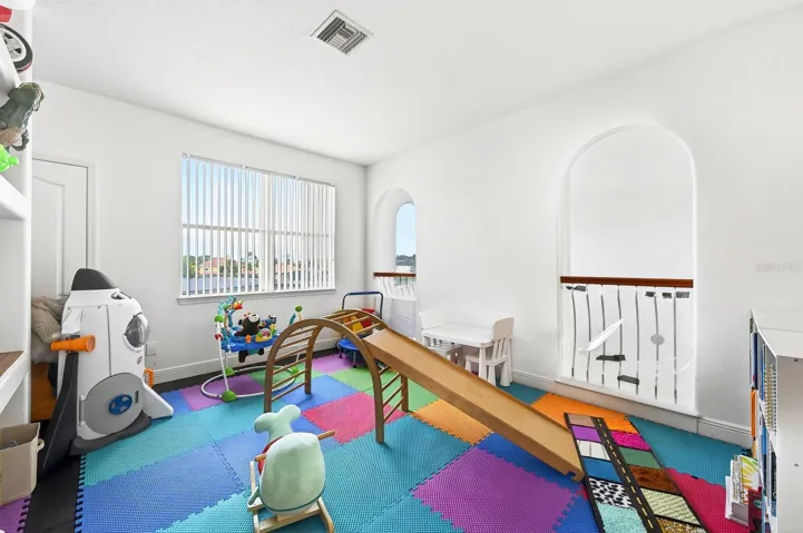A large bonus room with BUILT-IN SHELVING offers endless possibilities as a game room, media room, loft, home office, or playroom.