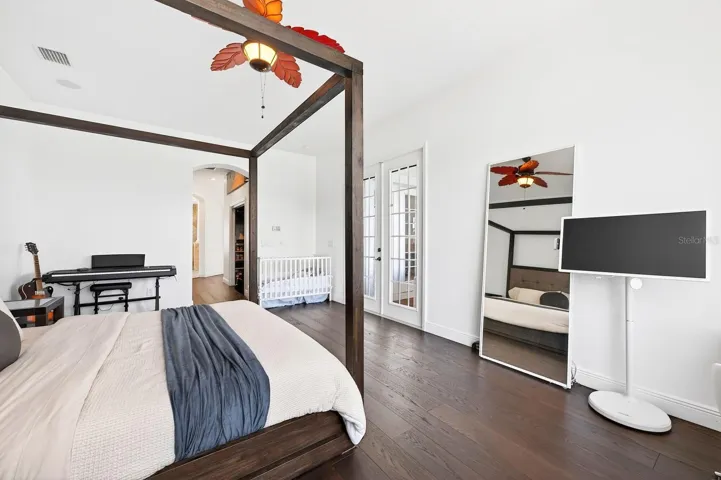 The luxurious Primary Suite serves as a private retreat with dual closets, a SPA-INSPIRED EN SUITE BATH, and french doors leading to the patio/pool area.