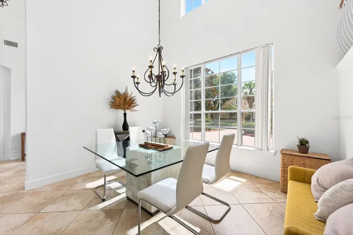 Nearby, the formal Dining Room is framed by large windows that fill the room with NATURAL LIGHT and provide lovely views of the front landscape.