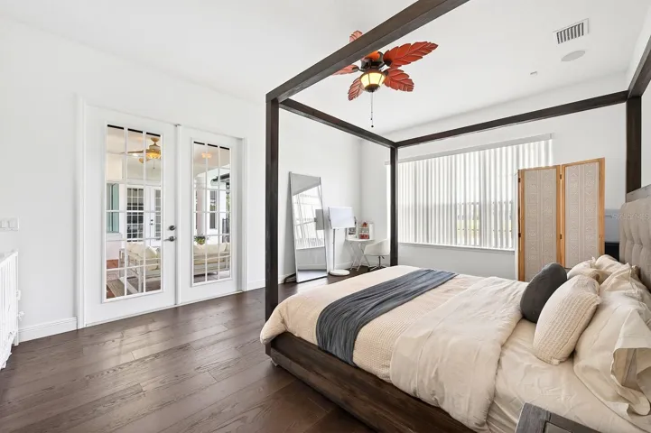 The luxurious Primary Suite serves as a private retreat with dual closets, a SPA-INSPIRED EN SUITE BATH, and french doors leading to the patio/pool area.