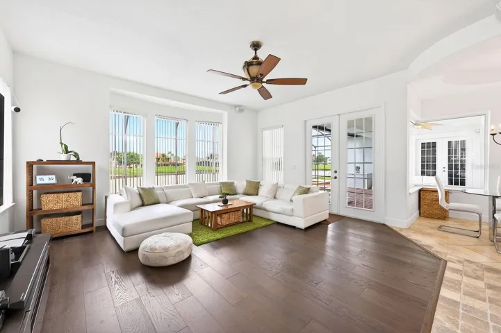 The Kitchen flows seamlessly into the EXPANSIVE FAMILY ROOM, where numerous windows and FRENCH DOORS flood the space with natural light.