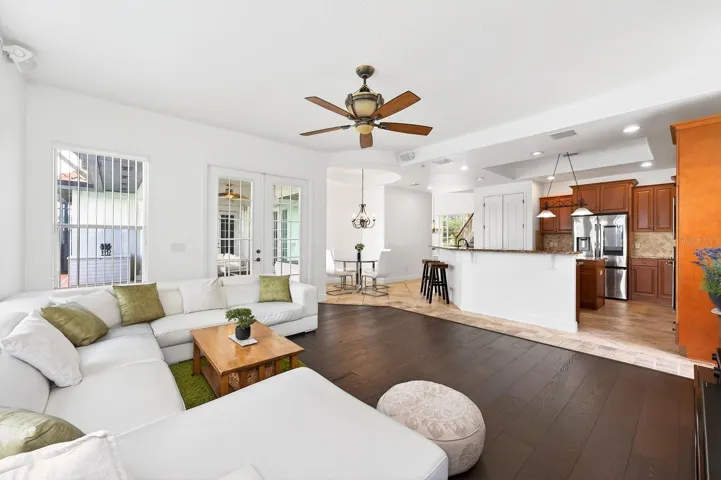 The Kitchen flows seamlessly into the EXPANSIVE FAMILY ROOM, where numerous windows and FRENCH DOORS flood the space with natural light.