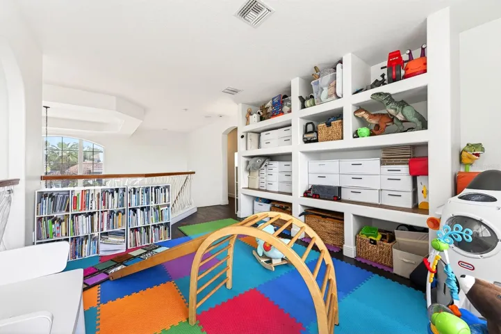 A large bonus room with BUILT-IN SHELVING offers endless possibilities as a game room, media room, loft, home office, or playroom.
