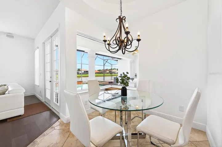 A SUNLIT BREAKFAST NOOK offers peaceful views of the pool and patio area.