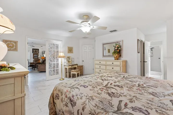 Another angle of Primary bedroom with French doors that open to Florida room