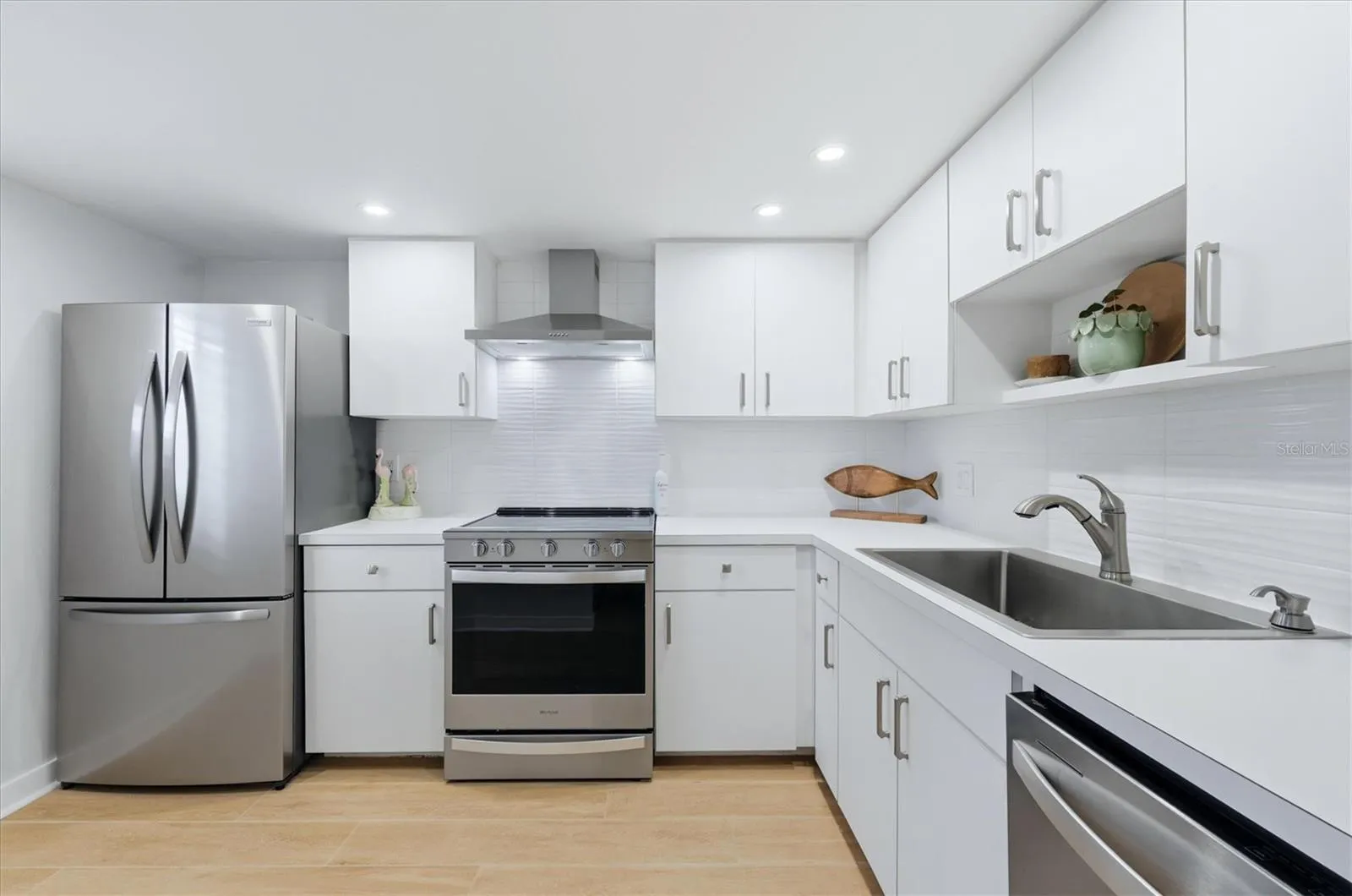 Spacious kitchen with upgraded appliances and backsplash