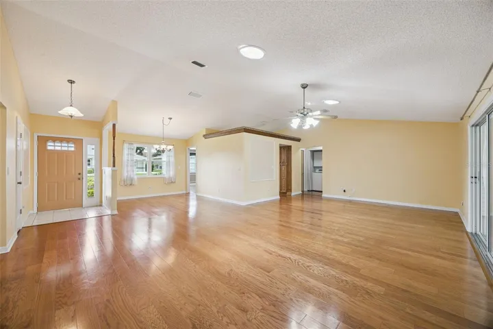 Living & dining combination with wood floors, solar tubes for loads of natural lighting, vaulted ceiling