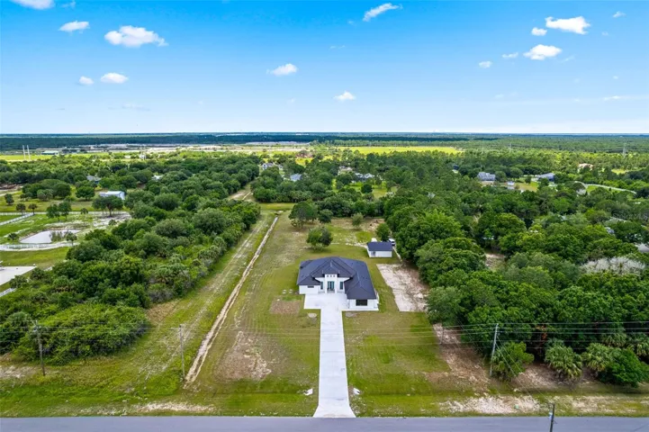 Aerial view showcasing the home’s position within a beautiful community