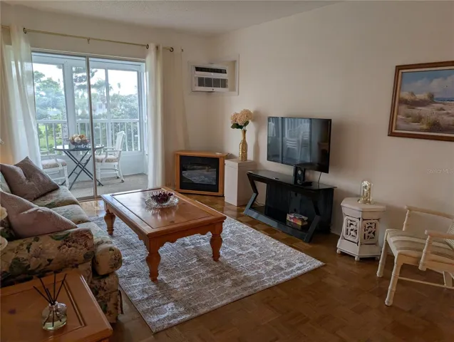 Living room  - gleaming parquet flooring, newer AC wall unit