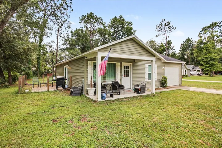 Large open backyard, pet-friendly side porch for outdoor grilling, & covered front porch for lemonade in summertime.