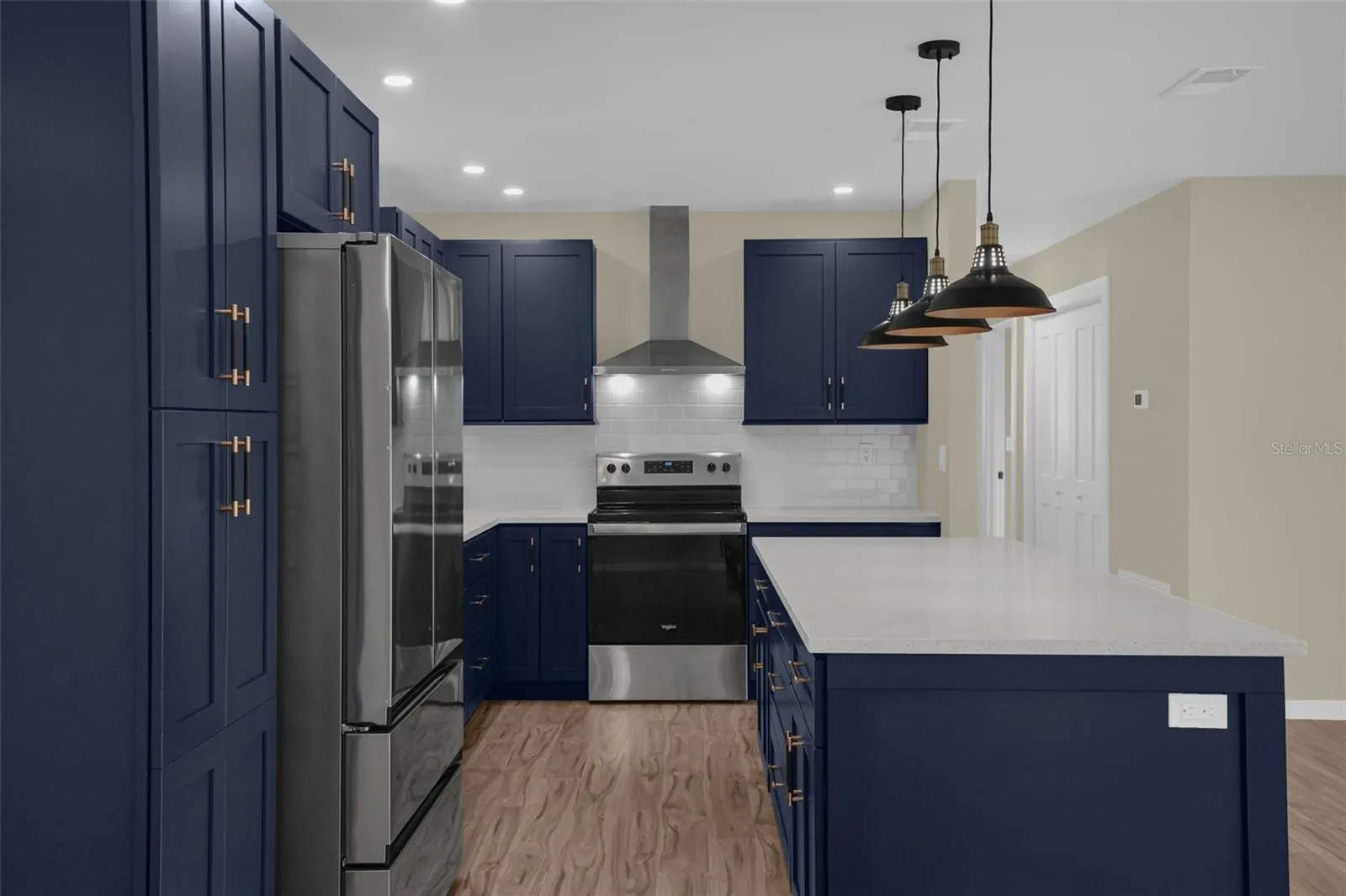 Spacious kitchen with redesigned layout, oversized sink, brand-new dishwasher, and abundant cabinet storage.