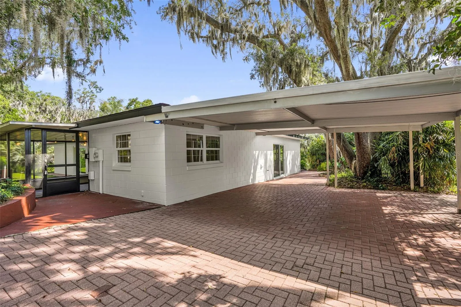 Covered carport with ample parking space, providing convenience for multiple vehicles and easy everyday access.
