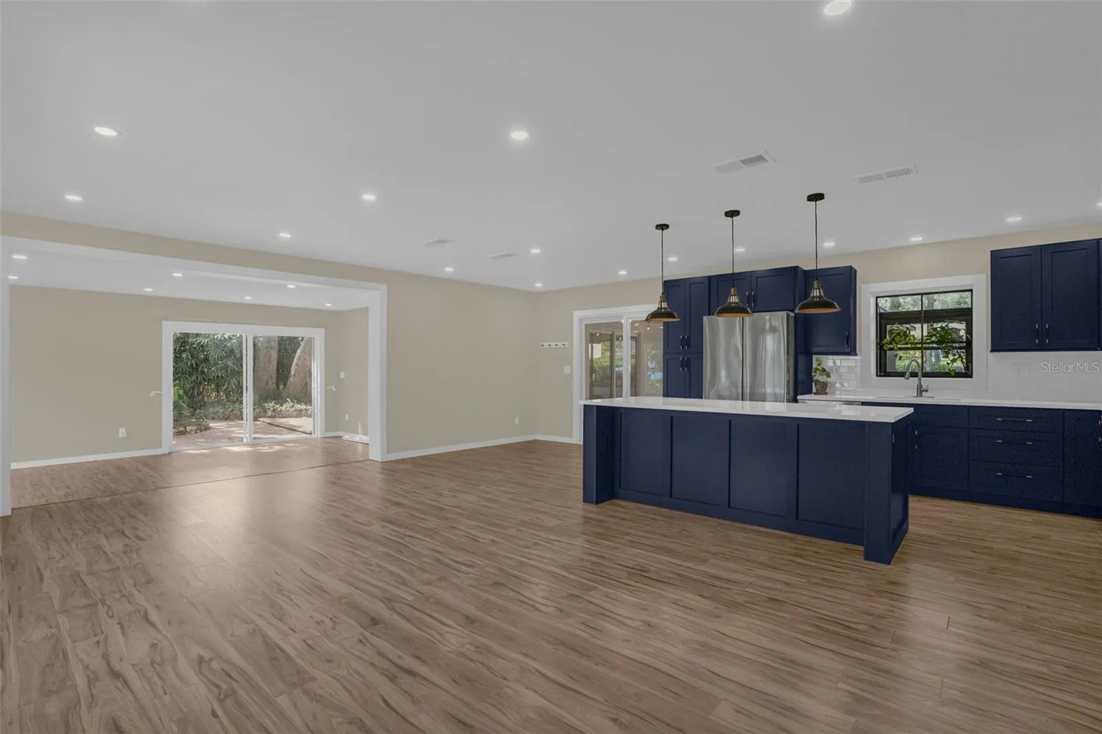 Completely remodeled kitchen (2026) with quartz countertops, soft-close cabinetry, designer backsplash, stainless steel appliances, and recessed lighting.