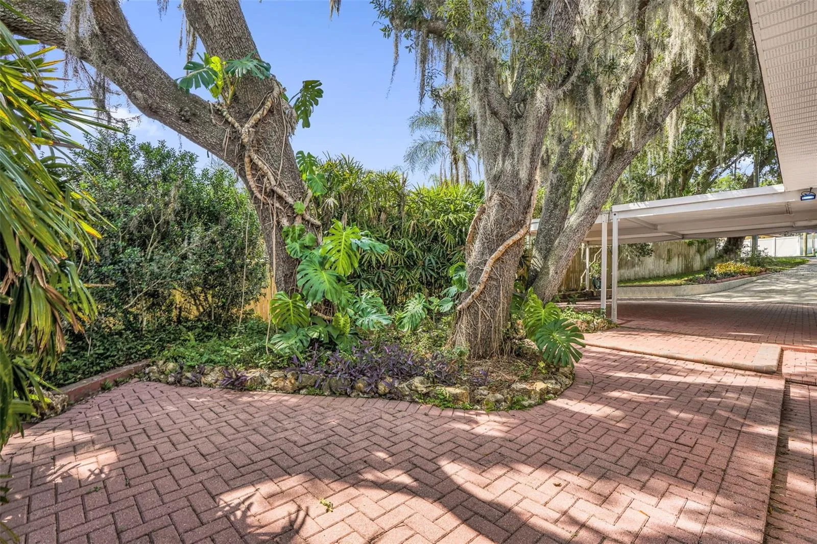 Extensive decorative paver driveway offering exceptional curb appeal, abundant parking, and welcoming access to the home.