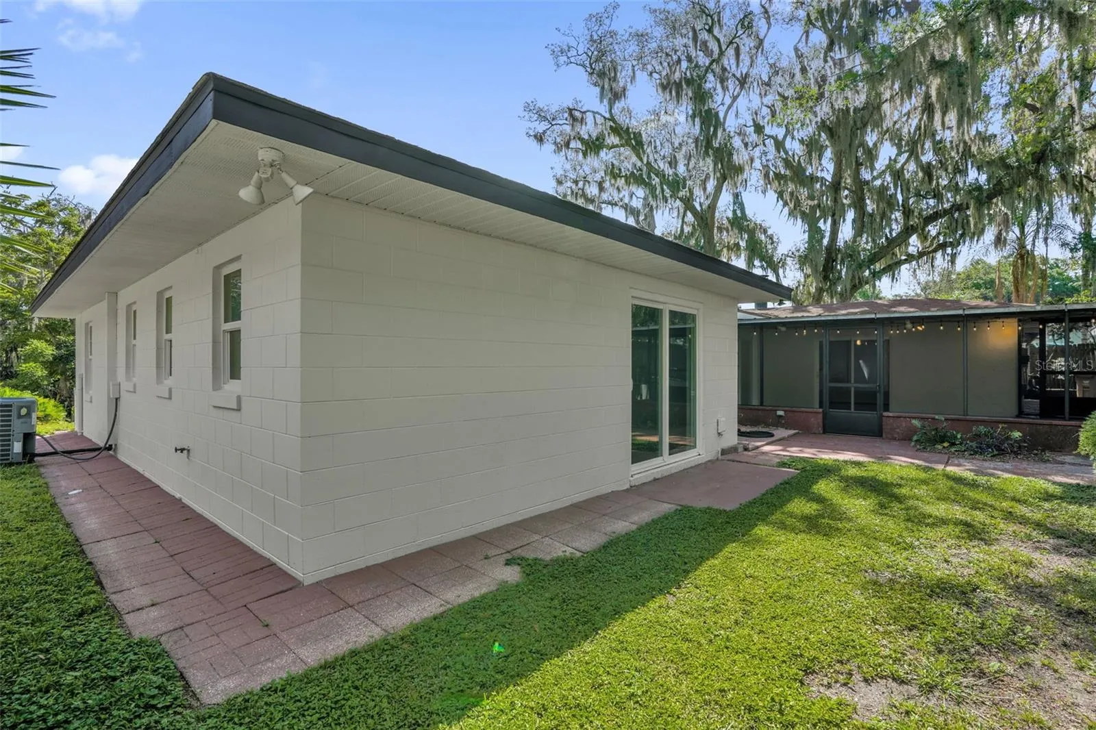 Private backyard retreat featuring mature oak trees, lush landscaping, and peaceful outdoor living spaces.